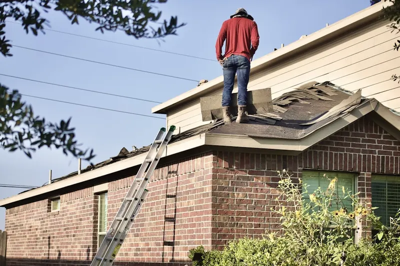 Professional roofer working on a residential roof in South Juanita